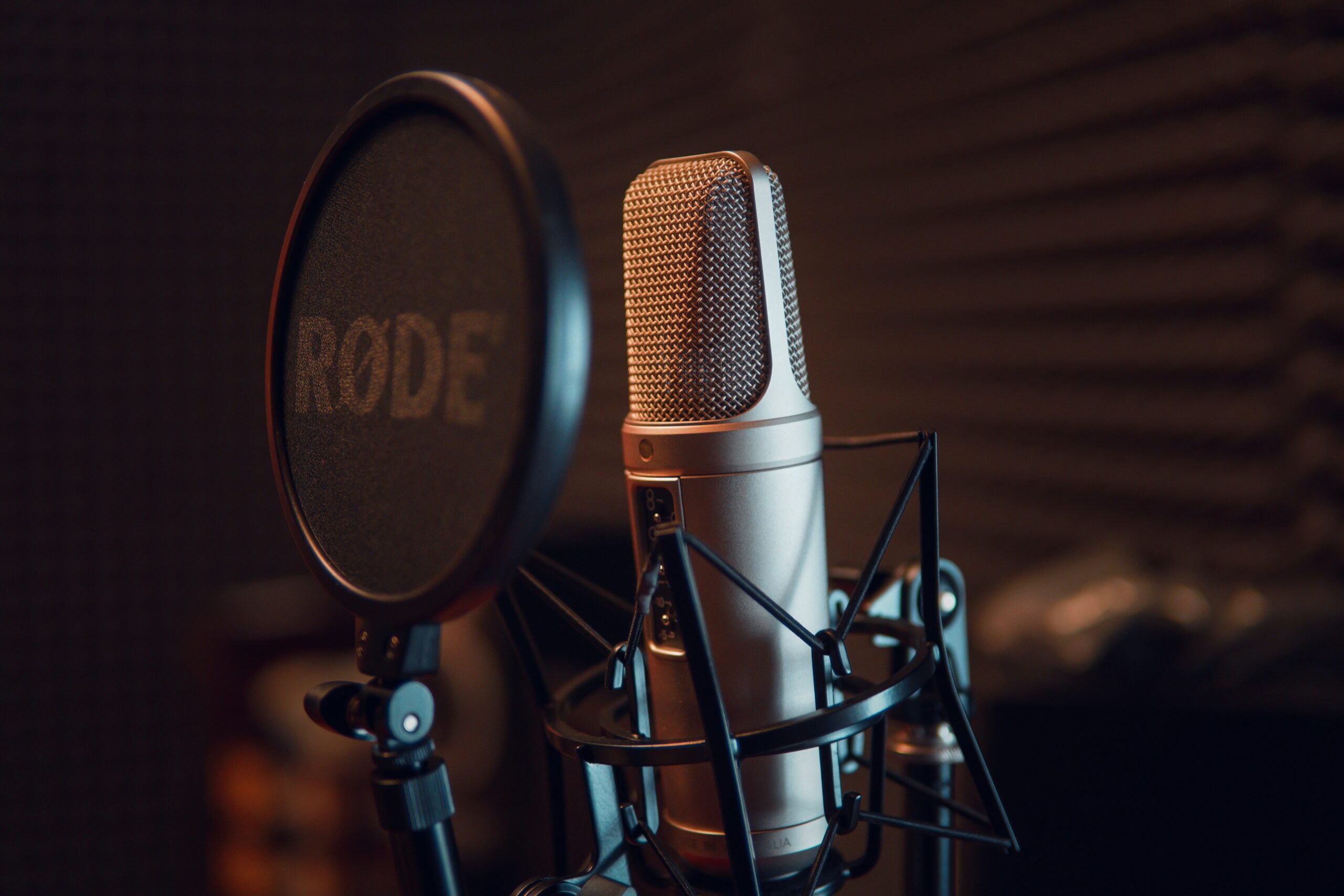 Rode microphone with pop cover in front of it. How to Choose the Best Microphone for Your Podcast