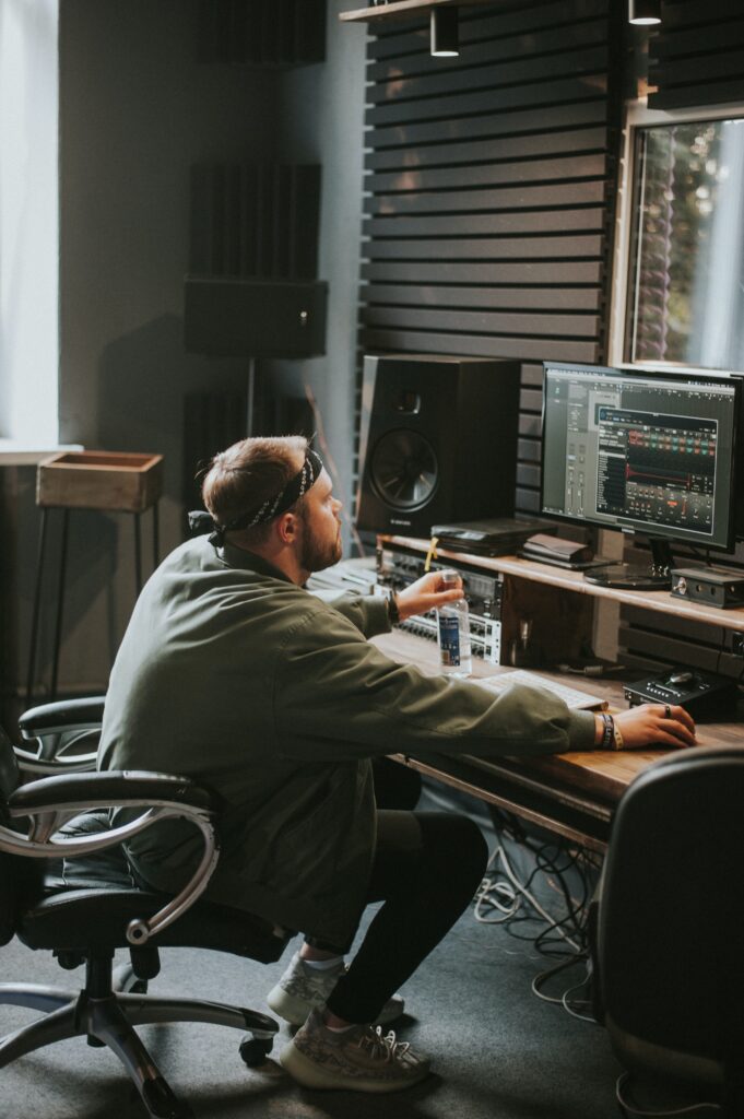 Man in home studio with studio monitors
